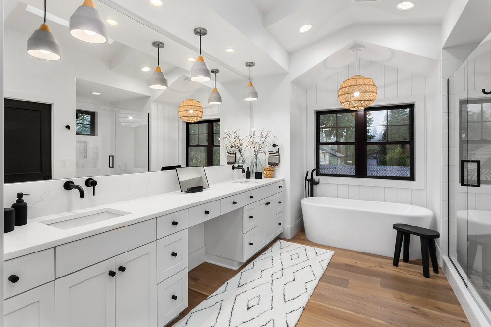 Bathroom in luxury home with double vanity, bathtub, mirror, sinks, shower, and hardwood floor, remodeling long grove BATHROOM REMODELING CONTRACTOR