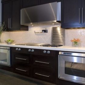 kitchen remodeling black kitchen cabinets, dark hardwood floor, white marble backsplash