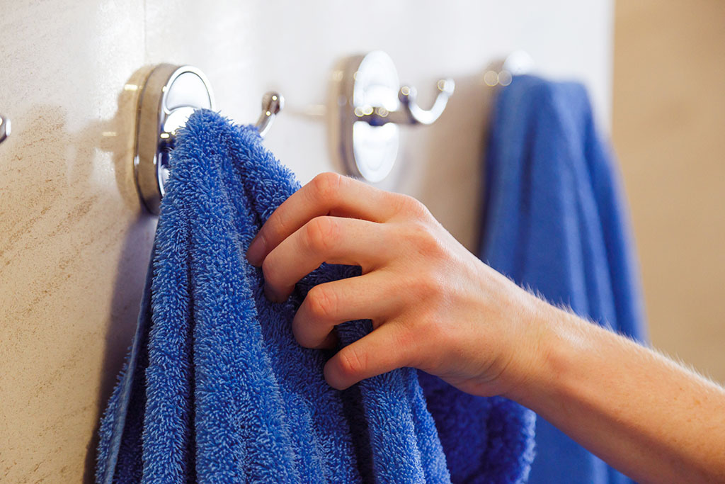 towel for hands hanging on a rack in the bathroom